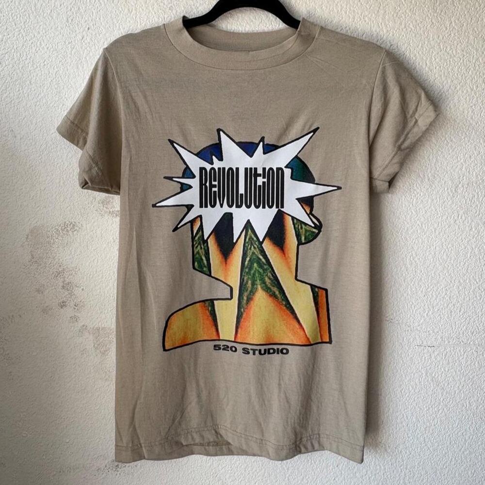 Womans tan tee featuring 'revolution' print
